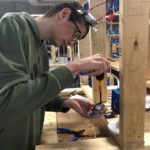 Sebastian Creech installing residential circuitry in the construction lab.